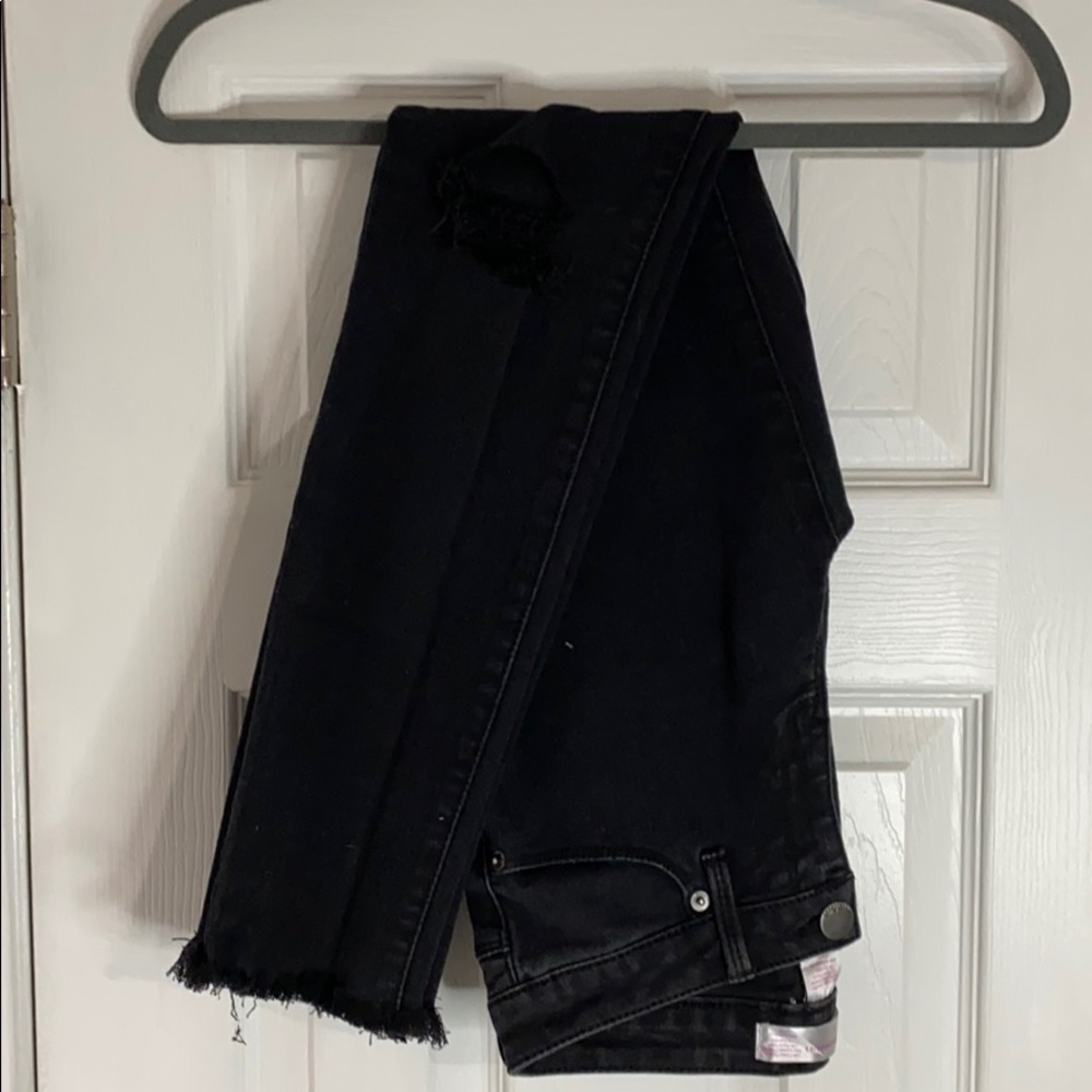 Black fringe and ripped jeans